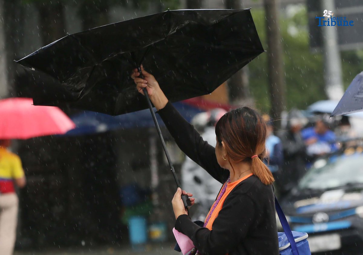 (September 23 2025) Commuters used umbrella to protect them selves from the rain brought by super typhoon Nando, while waiting a public transport along Commonwealth in Quezon City on Tuesday September 23 2025. Photo/Analy Labor