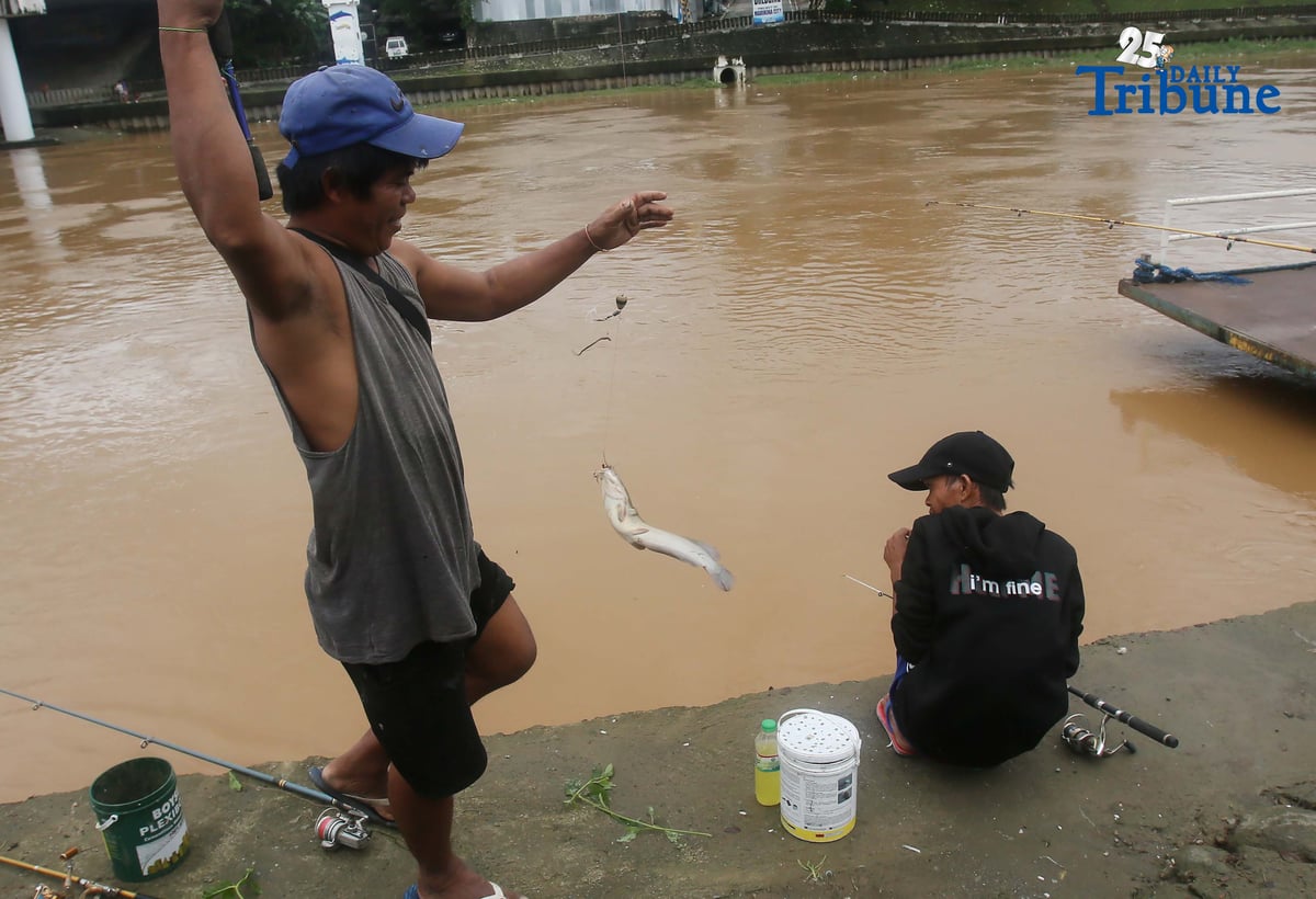 A man caught a catfish using a fishing rod along the normal-level Marikina River at Marikina Park on Friday afternoon, September 26, 2025.
Typhoon Opong has weakened into a severe tropical storm, PAGASA said, but warned residents to remain alert for hazards such as floods, landslides, and storm surges.
Photo by Analy Labor