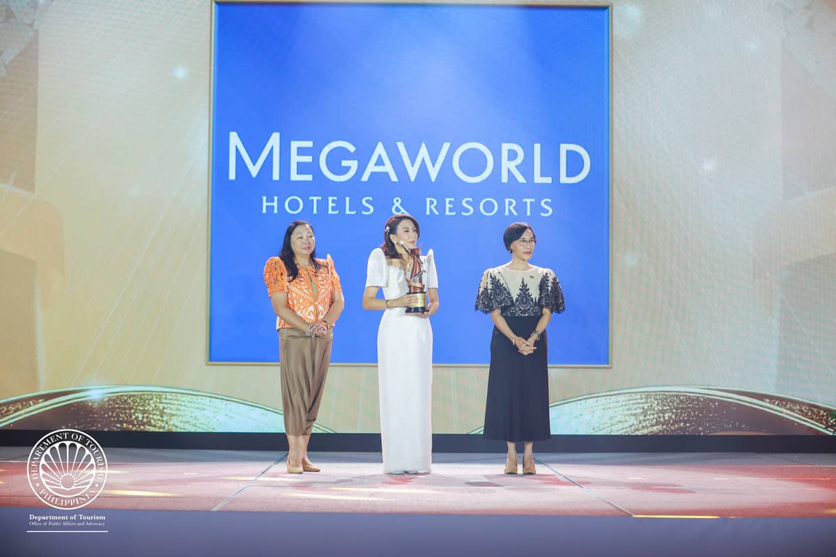 Tourism Secretary Christina Garcia Frasco (center) presents the Philippine Tourism Award to Megaworld Hotels & Resorts during the inaugural ceremony held at Okada Manila.