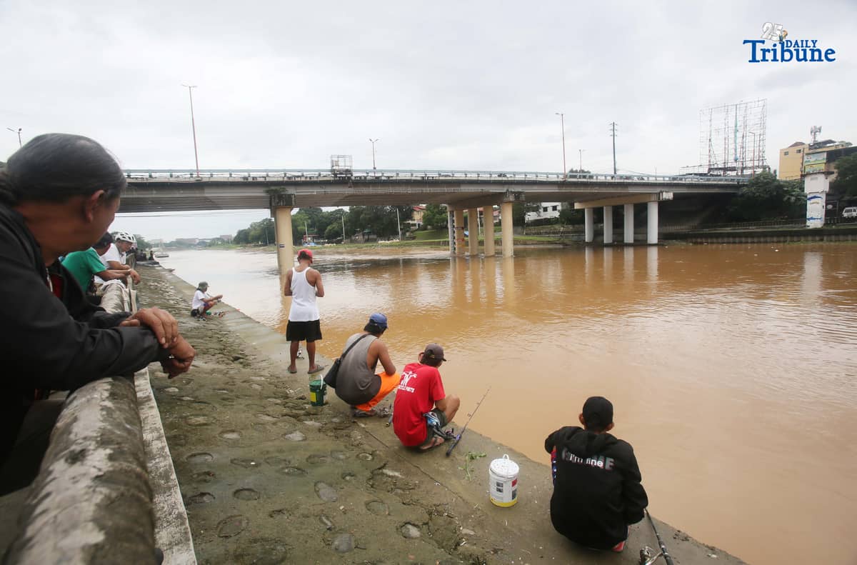 People were seen fishing along the Marikina River at Marikina River Park on Friday, September 26, 2025, as Typhoon Opong weakened into a severe tropical storm.
Opong, previously classified as a typhoon, was downgraded by PAGASA, which warned the public to remain on alert for possible hazards, including floods, landslides, and storm surges.