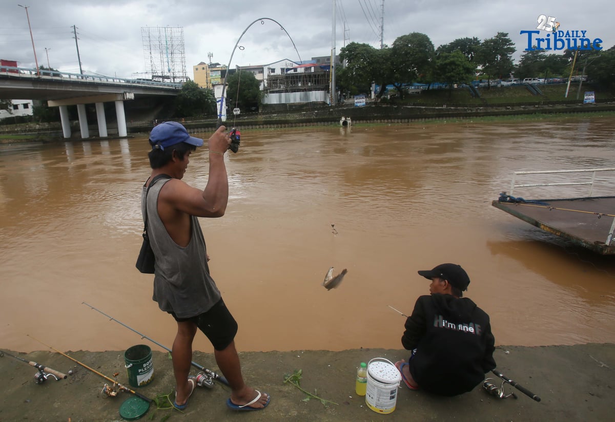 A man caught a catfish using a fishing rod along the normal-level Marikina River at Marikina Park on Friday afternoon, September 26, 2025.
Typhoon Opong has weakened into a severe tropical storm, PAGASA said, but warned residents to remain alert for hazards such as floods, landslides, and storm surges.
Photo by Analy Labor