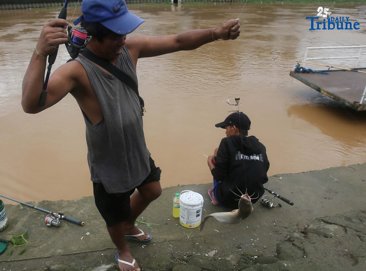 A man caught a catfish using a fishing rod along the normal-level Marikina River at Marikina Park on Friday afternoon, September 26, 2025.
Typhoon Opong has weakened into a severe tropical storm, PAGASA said, but warned residents to remain alert for hazards such as floods, landslides, and storm surges.
Photo by Analy Labor