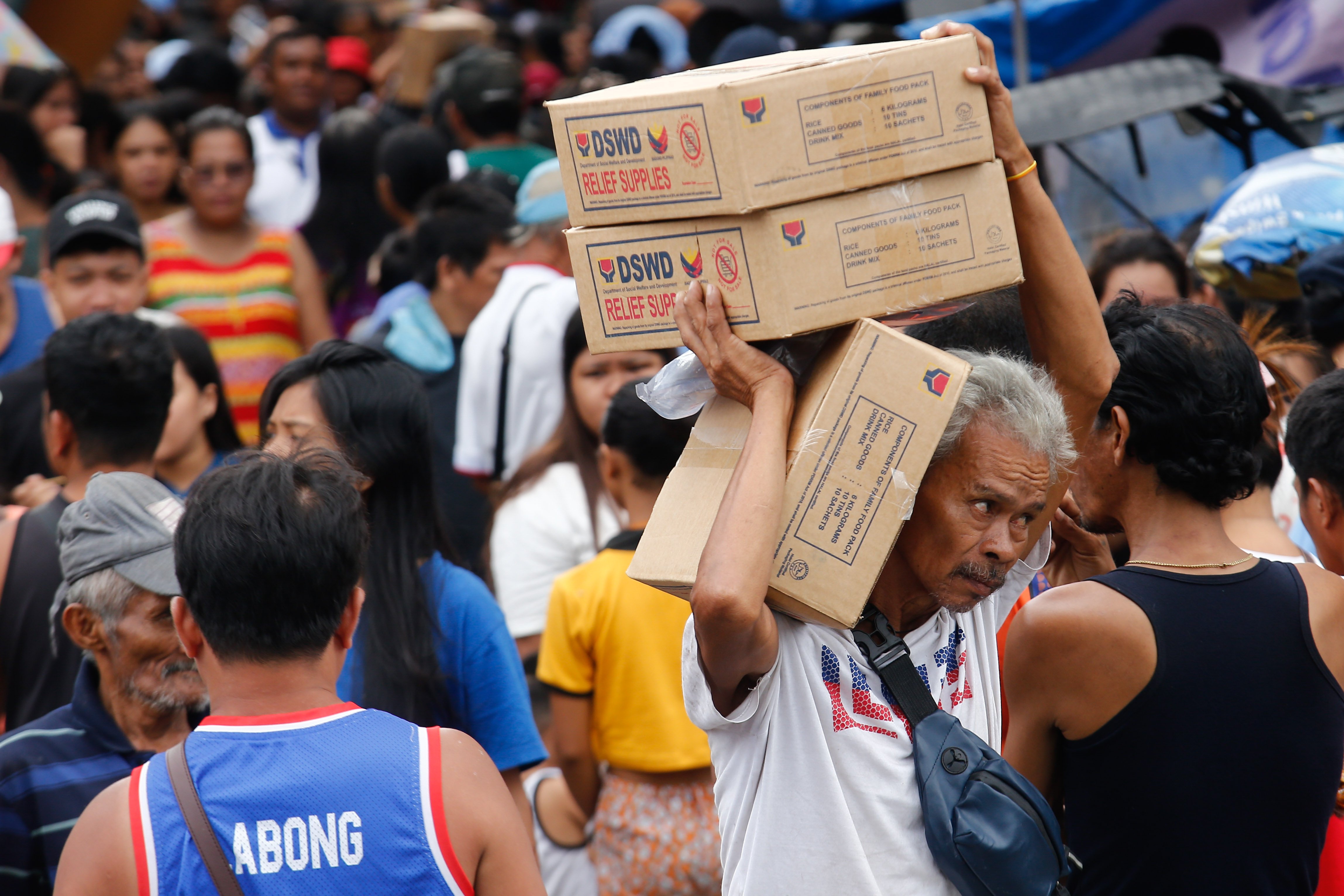 Happyland residents line up for food packs