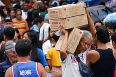 Happyland residents line up for food packs