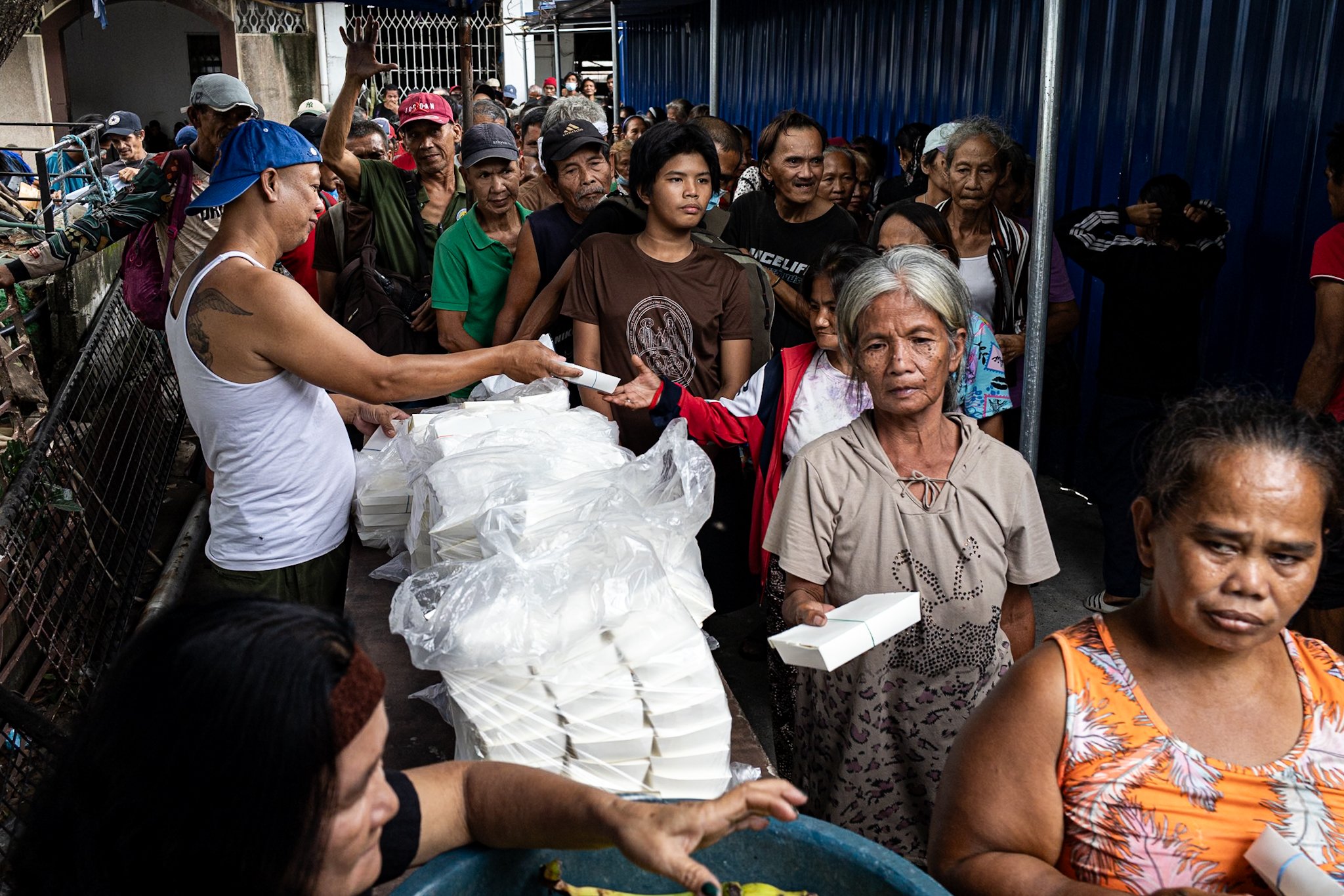 Photos show people lining up for food packs in Manila