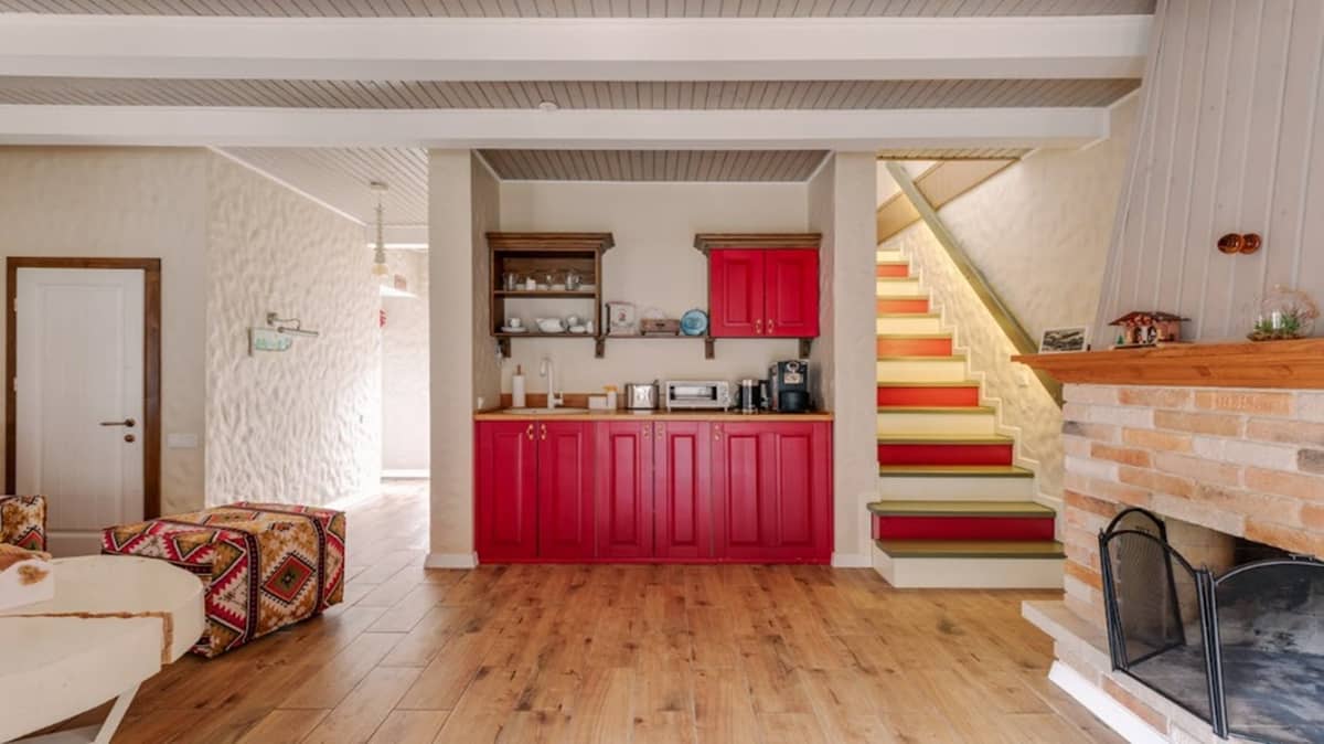 Kitchen cabinets, staircase and couches with a touch of warm colors.