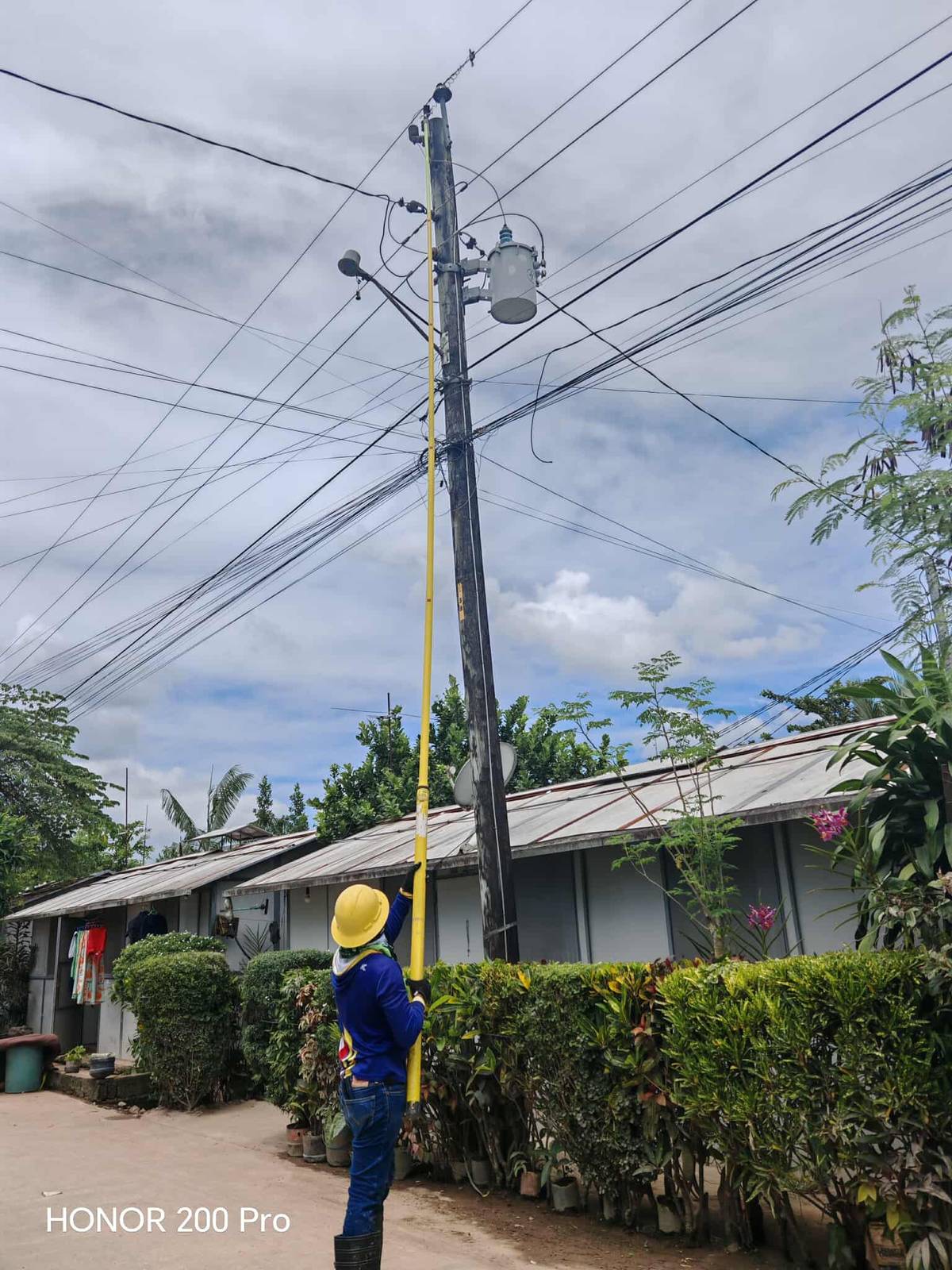POWER is being restored to the village by a worker of Leyte V Electric Cooperative Inc. on 28 September.