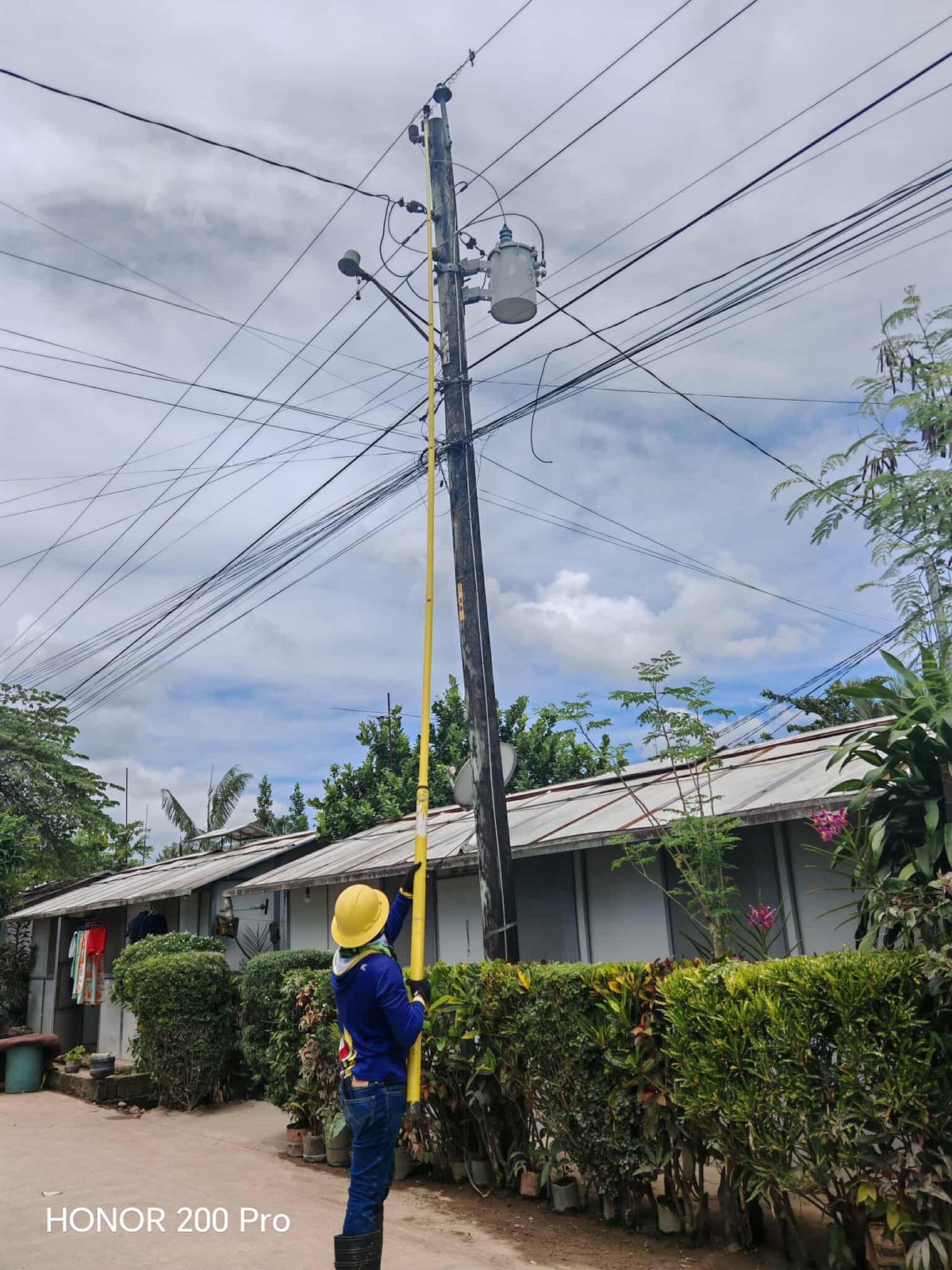 POWER is being restored to the village by a worker of Leyte V Electric Cooperative Inc. on 28 September.