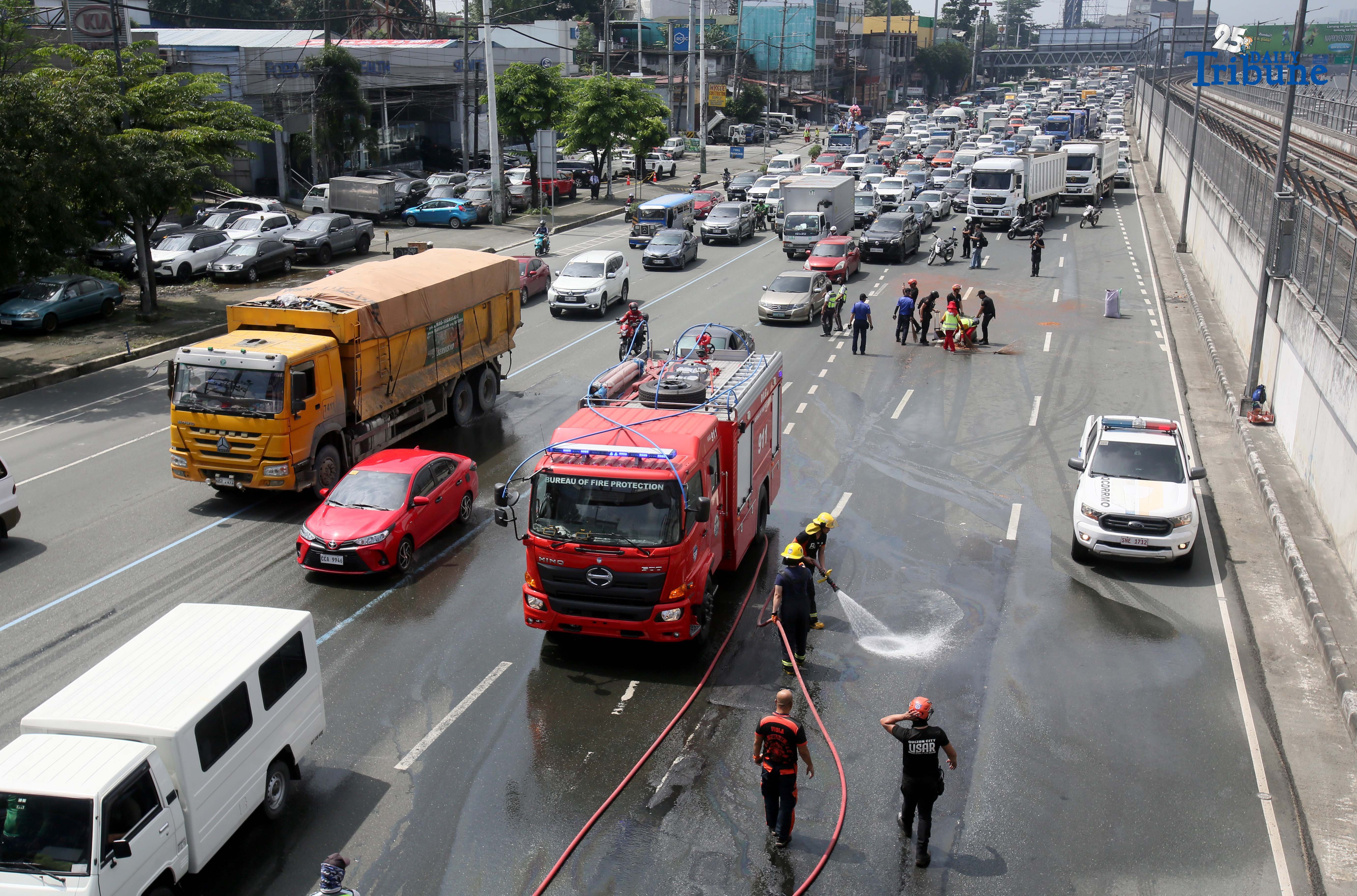 (October 11 2025) To avoid an accident  Bureau of Fire Protection BFP personnel used water cannons to remove the oil spilled from the truck scattered along Commonwealth Avenue in Quezon City on Saturday October 11 2025, and it caused a heavy traffic.  Photo/Analy Labor