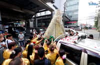 Devotees welcome the image of the La Naval with prayers during the parade of the holy image at churches within District 3 and 4 of Quezon City on Saturday, 11 October 2025.
