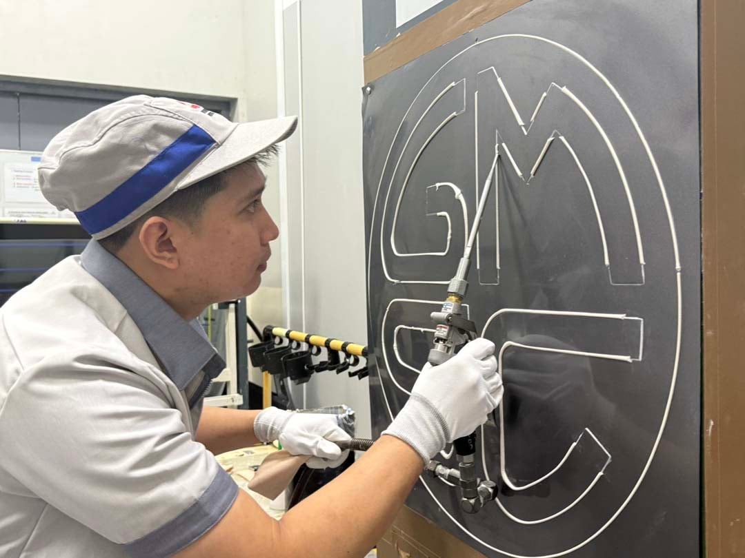 PAINTING representative John Carlo de Leon practices precision coating ahead of the Global Monozukuri Skill Competition.