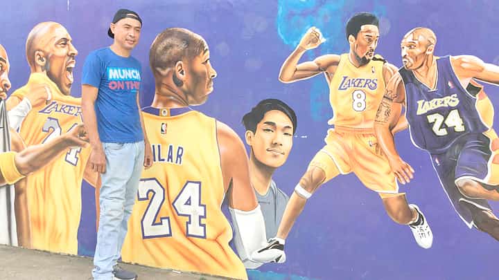 Batain with his mural in Malvar.