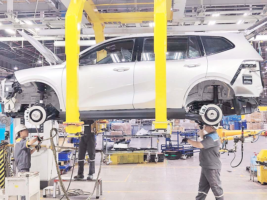 TECHNICIANS assemble a VinFast vehicle at the Hai Phong manufacturing plant, where automation and precision guide production.