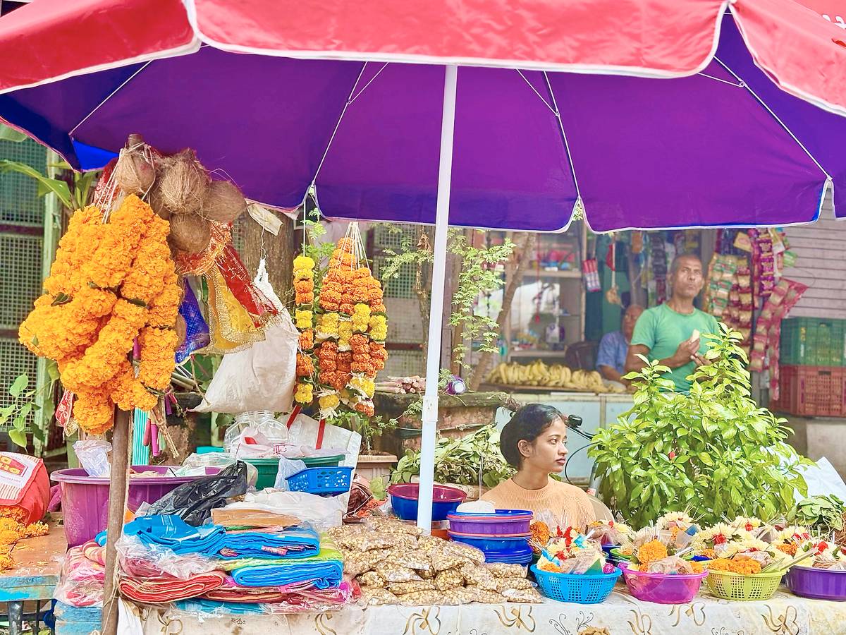 A girl at a Mumbai wet market: narrow aisles piled with fish, vegetables and every imaginable commodity, largely run by Koli women.