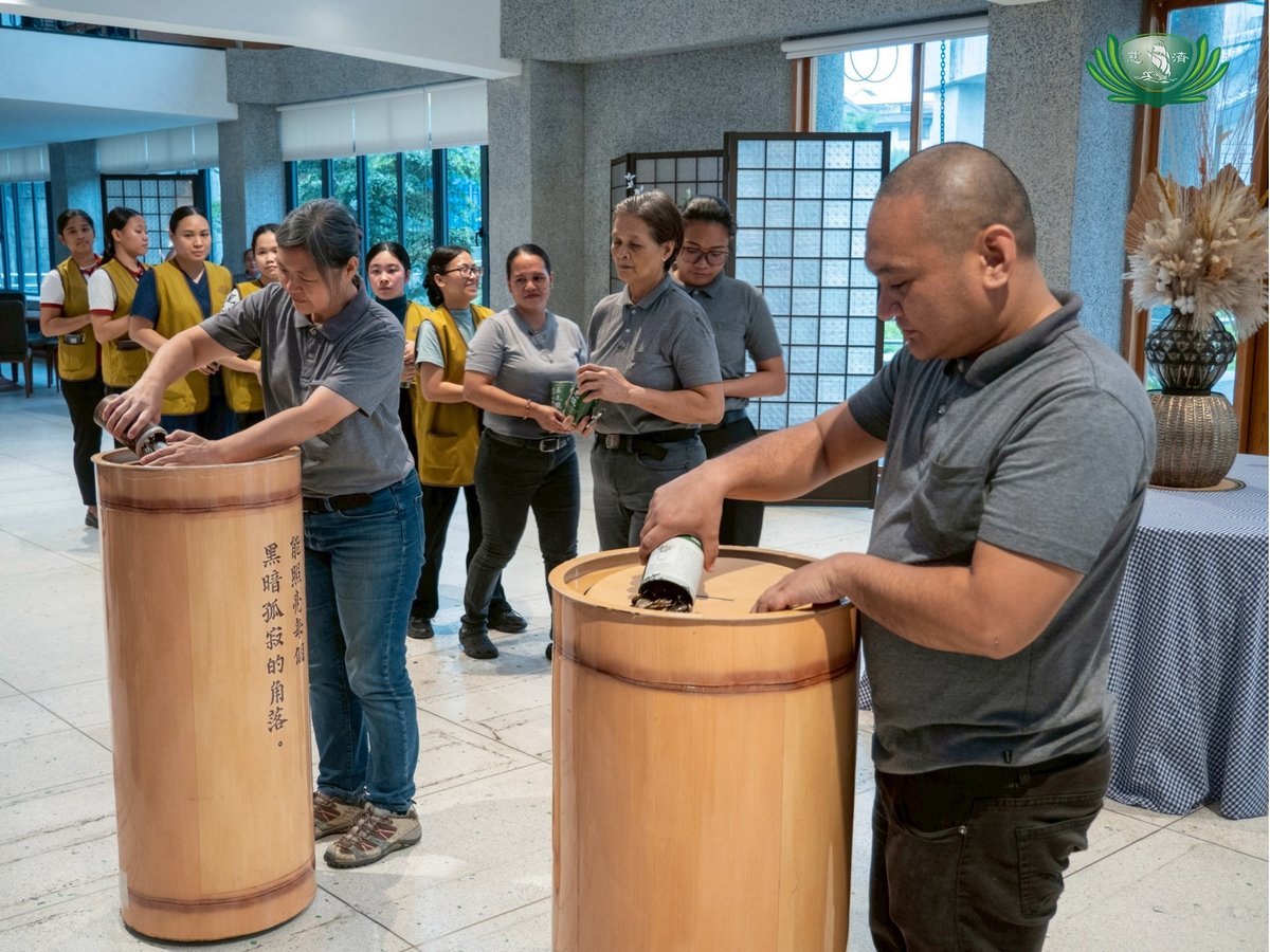 TZU Chi staff (above) pour their coin banks unto a large donation container in Manila