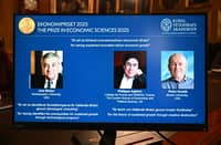 A screen displays the portraits of the 2025 prize winners (L-R) Joel Mokyr, Philippe Aghion and Peter Howitt, during the announcement of the winners of the 2025 Nobel Prize in Economics, the Sveriges Riksbank Prize in Economic Sciences in Memory of Alfred Nobel, at the Royal Swedish Academy of Sciences in Stockholm, Sweden, on October 13, 2025. The Nobel prize in economics was awarded to American-Israeli Joel Mokyr, France's Philippe Aghion and Canada's Peter Howitt for work on technology's impact on sustained economic growth.