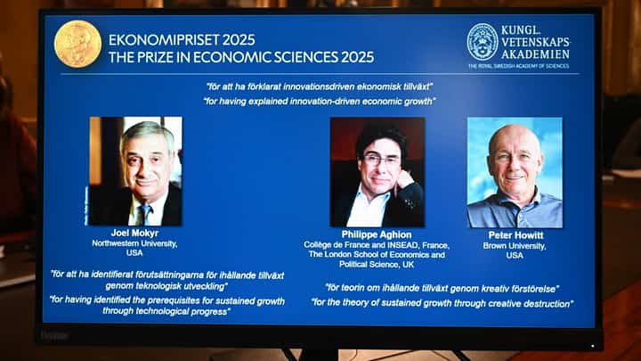 A screen displays the portraits of the 2025 prize winners (L-R) Joel Mokyr, Philippe Aghion and Peter Howitt, during the announcement of the winners of the 2025 Nobel Prize in Economics, the Sveriges Riksbank Prize in Economic Sciences in Memory of Alfred Nobel, at the Royal Swedish Academy of Sciences in Stockholm, Sweden, on October 13, 2025. The Nobel prize in economics was awarded to American-Israeli Joel Mokyr, France's Philippe Aghion and Canada's Peter Howitt for work on technology's impact on sustained economic growth.