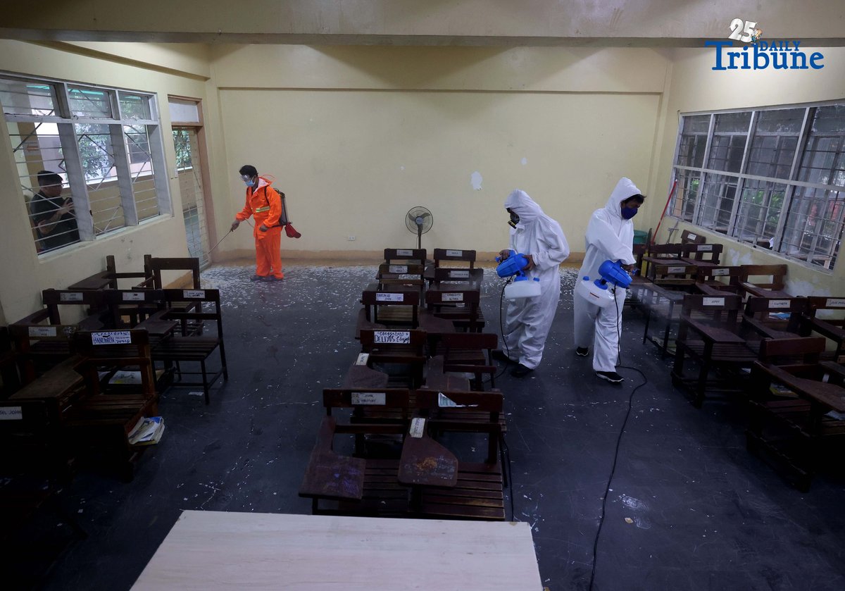 (October 14 2025) On Tuesday October 14 2025, volunteer Parent Teacher Association PTA, faculty members wearing personal protective equipment and conducting disinfection of the classrooms and common areas by using a water based solution, at Quezon City High School. Photo/Analy Labor