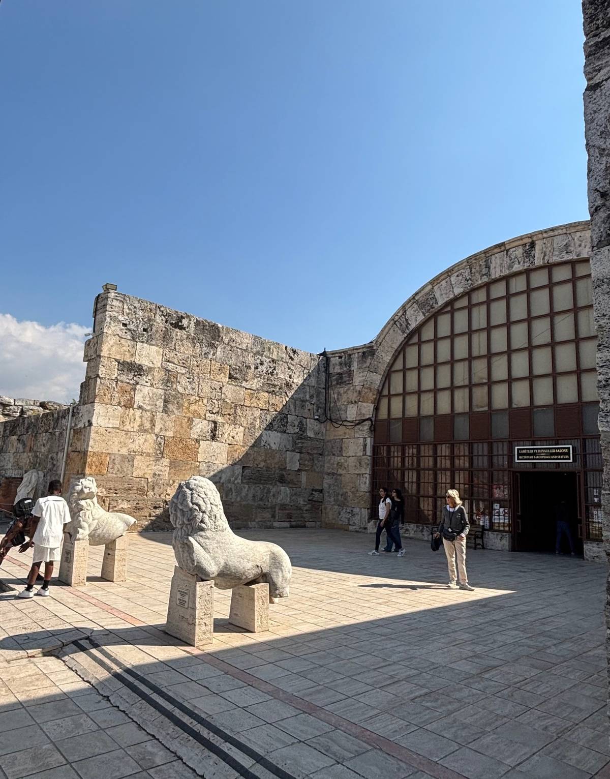 Two ancient lions stand before the entrance of Hierapolis Museum.