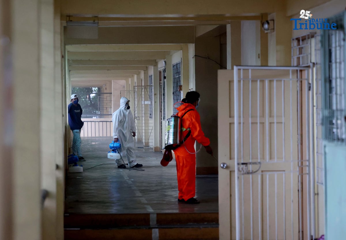 (October 14 2025) On Tuesday October 14 2025, volunteer Parent Teacher Association PTA, faculty members wearing personal protective equipment and conducting disinfection of the classrooms and common areas by using a water based solution, at Quezon City High School. Photo/Analy Labor