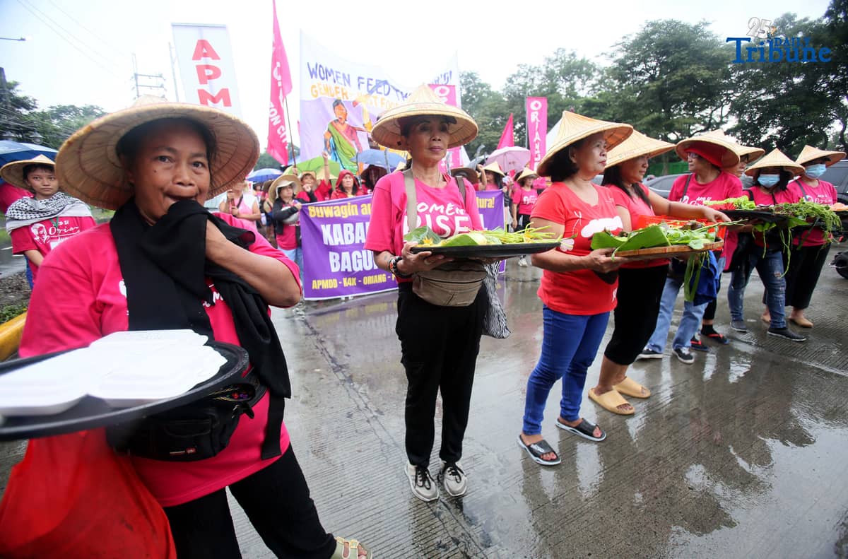 (October 15 2025) Militant group Oriang, K4K, Asian Peoples’ Movement on Debt and Development (APMDD), Philippine Movement for Climate Justice (PMCJ), Aniban ng Manggagawa sa Agrikultura (AMA, carrying vegetables as symbolize of their protest and march to the Department of Agriculture in Quezon City, to demand food for people, and accountability in the massive corruption palauging the national government and landlessness among poor peasants as they mark International Rural Women's Day on Wednesday. Photo/Analy Labor