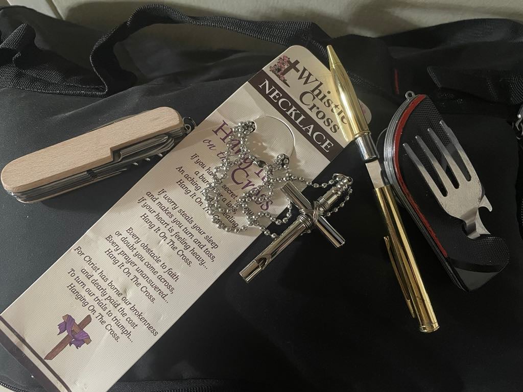 WHISTLE cross necklace and ballpen that turns into a knife.
