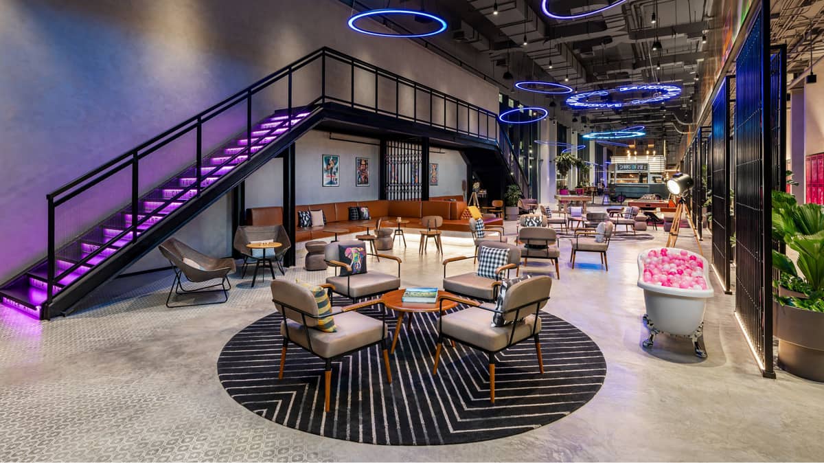 Moxy Bangkok’s lofted lounge area is a communal space for playing games, and hanging out among artwork that depict Bangkok’s landmarks and culture.