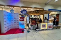 HOME Credit booth stands outside Abenson-Bulacan for the midnight launch of Apple’s iPhone 17 series.