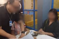 FAST-FOOD FRAUD | NBI agents apprehend Jenny Macanas Sapad, a.k.a. "Sheila Castillo," in a Tarlac City fast-food chain for allegedly posing as a lawyer and swindling a victim of ₱5 million. Sapad faces charges including syndicated estafa, falsification of documents, and usurpation of authority. October 24, 2025.| Franco Regala