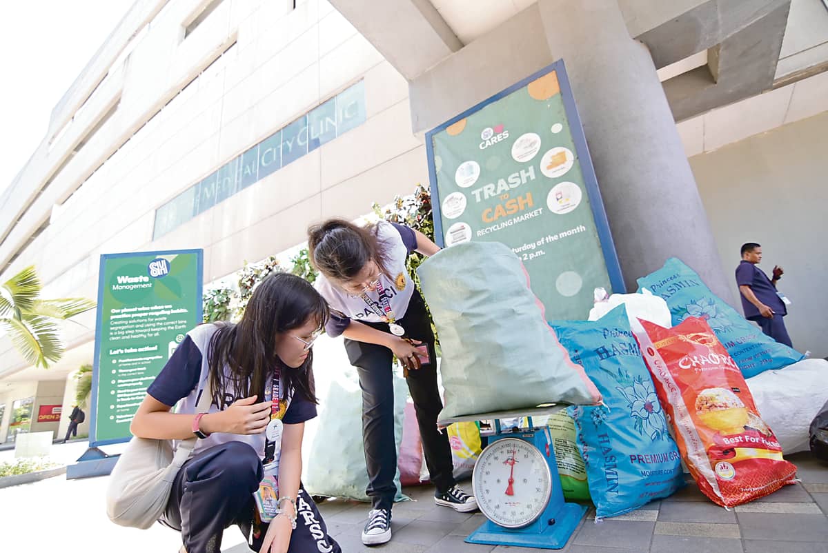 Students weigh recyclables during SM Cares’  Trash to Cash, showing that small actions can lead to a greener future.