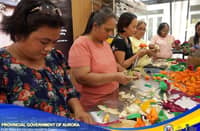 Women making corn husk flowers at the training room of the LEDIP-C in Baler, Aurora.