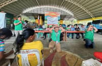 Participants duck, cover, and hold during the regionwide earthquake and tsunami drill in Banate, Iloilo, on Oct. 23, 2025, organized by the Provincial Disaster Risk Reduction and Management Office (PDRRMO) together with the Banate MDRRMO and barangay officials.