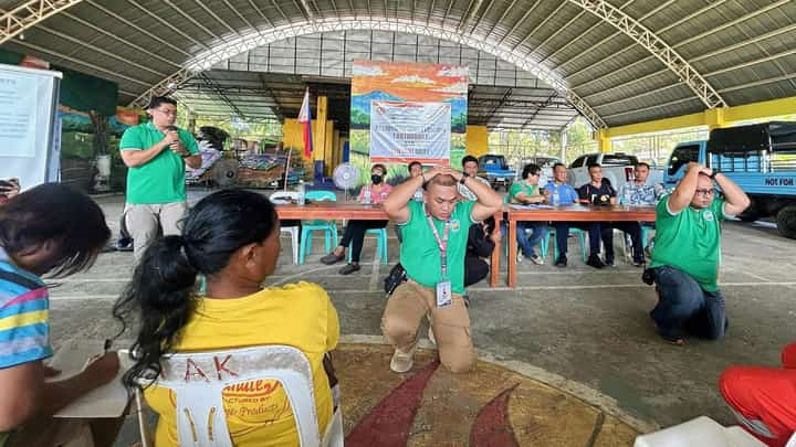 Participants duck, cover, and hold during the regionwide earthquake and tsunami drill in Banate, Iloilo, on Oct. 23, 2025, organized by the Provincial Disaster Risk Reduction and Management Office (PDRRMO) together with the Banate MDRRMO and barangay officials.