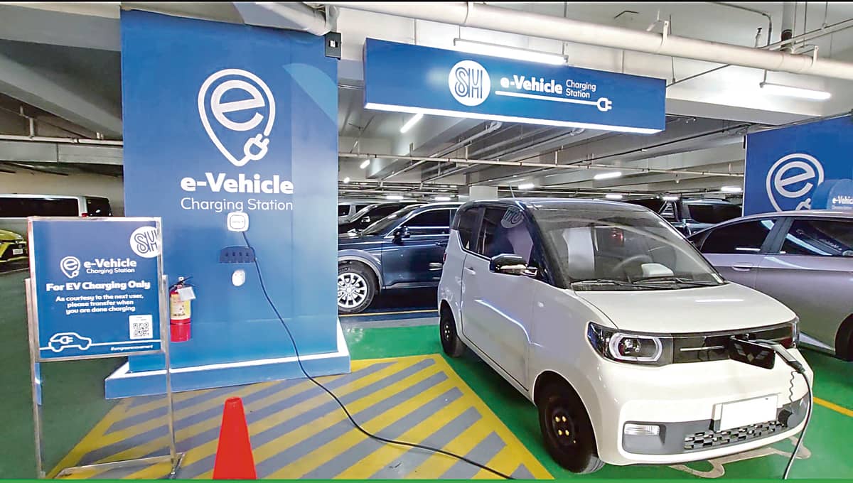 An electric vehicle charges at SM North EDSA’s Electric Vehicle Charging Station — one of 123 across 69 SM Supermalls nationwide.