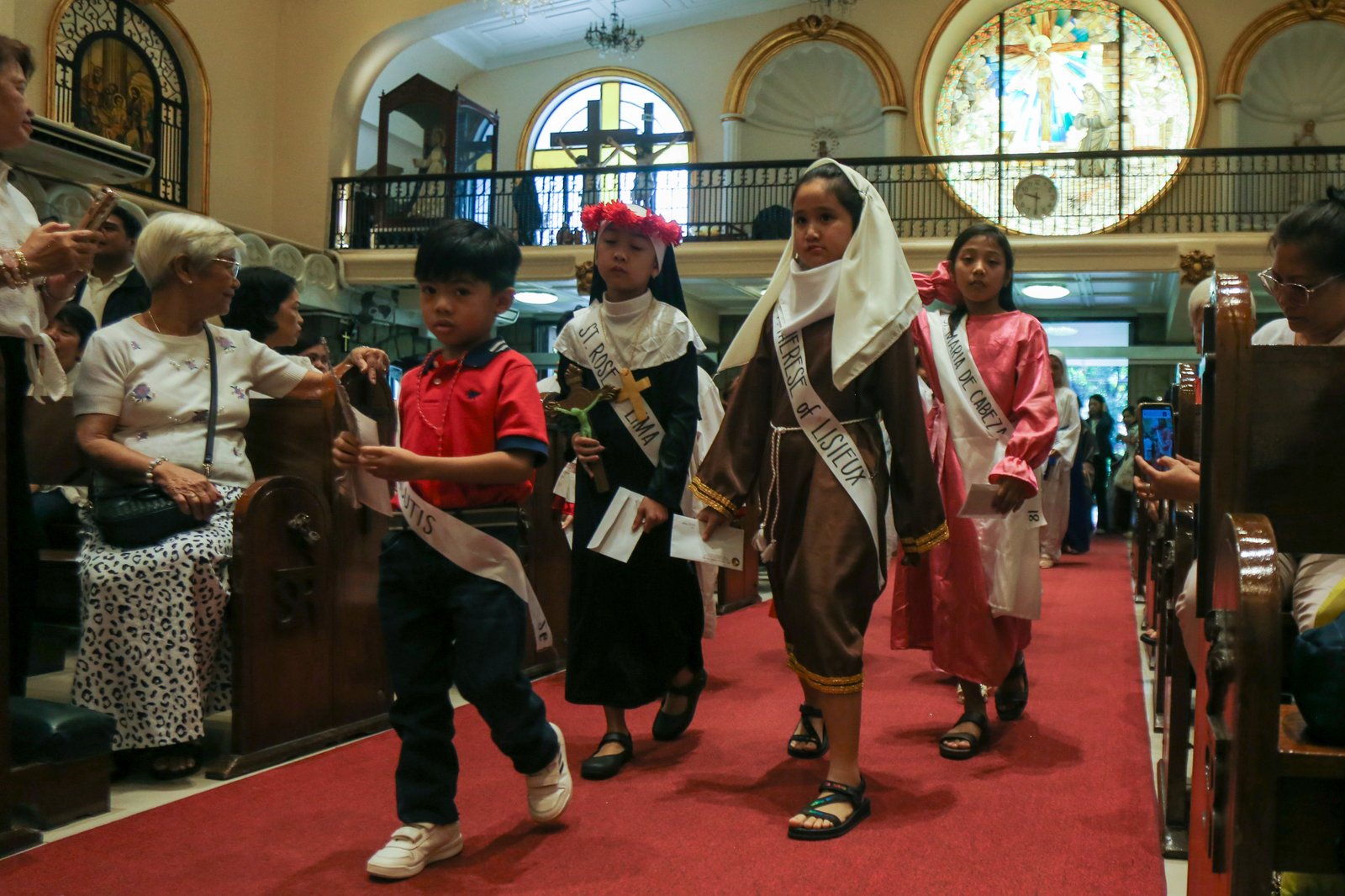 Children flock to Sta. Rita de Cascia Parish at PhilAm Homes in Quezon City on the morning of 26 October 2025 for their annual Parade of Saints. The parade aims to encourage the young to emulate the lives of the Catholic saints.