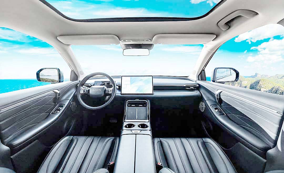 CABIN view shows AION’s clean layout and panoramic roof under bright skies.