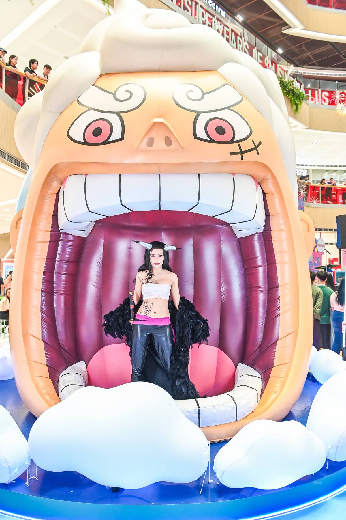 Cosplayer Myrtle Sarrosa (dressed as Nico Robin) strikes a pose at the supersized ‘One Piece’ display.