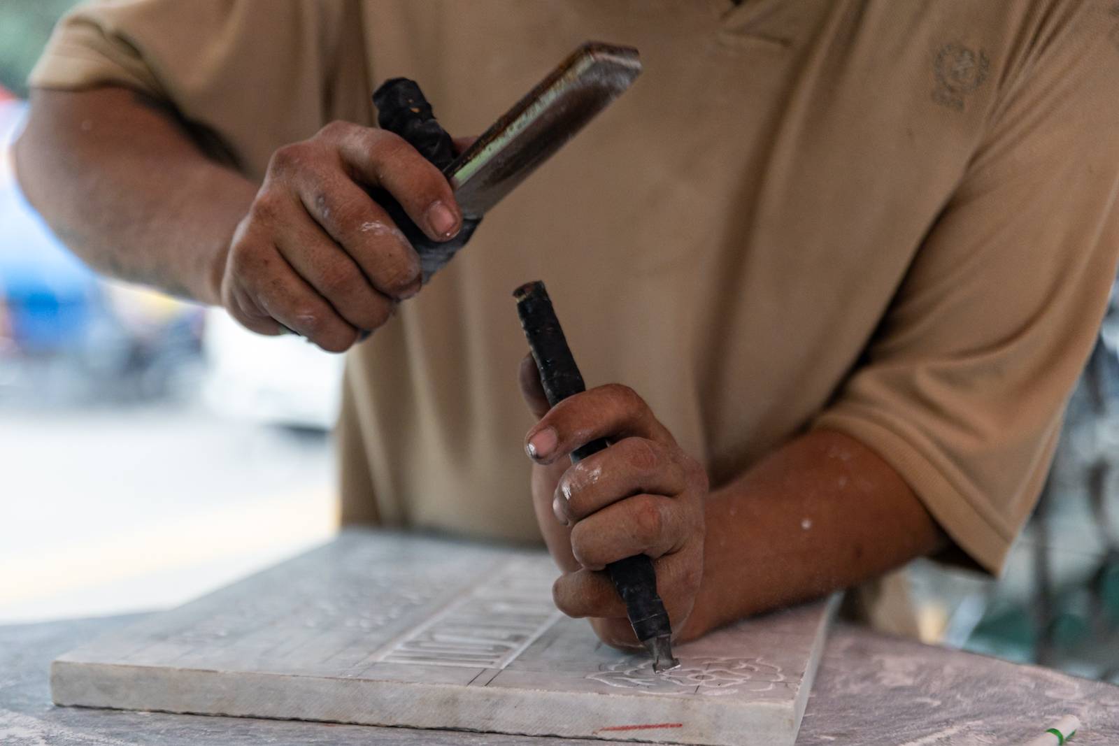 Tombstone maker Socsoc Gamurot engraves and paints names on a marble slab at his makeshift workshop inside the Manila North Cemetery as the annual observance of All Saints’ Day approaches.

 he 40-year-old, who resides inside the country’s largest cemetery, shares that each tombstone costs ₱1,200 and that he crafts an average of 10 pieces a day.