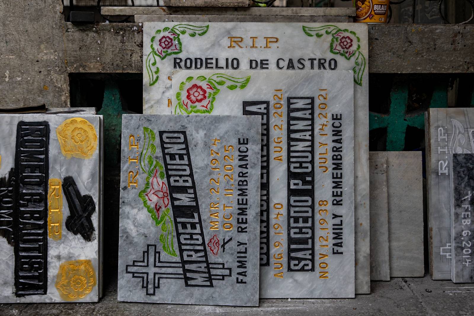 Tombstone maker Socsoc Gamurot engraves and paints names on a marble slab at his makeshift workshop inside the Manila North Cemetery as the annual observance of All Saints’ Day approaches.

 he 40-year-old, who resides inside the country’s largest cemetery, shares that each tombstone costs ₱1,200 and that he crafts an average of 10 pieces a day.