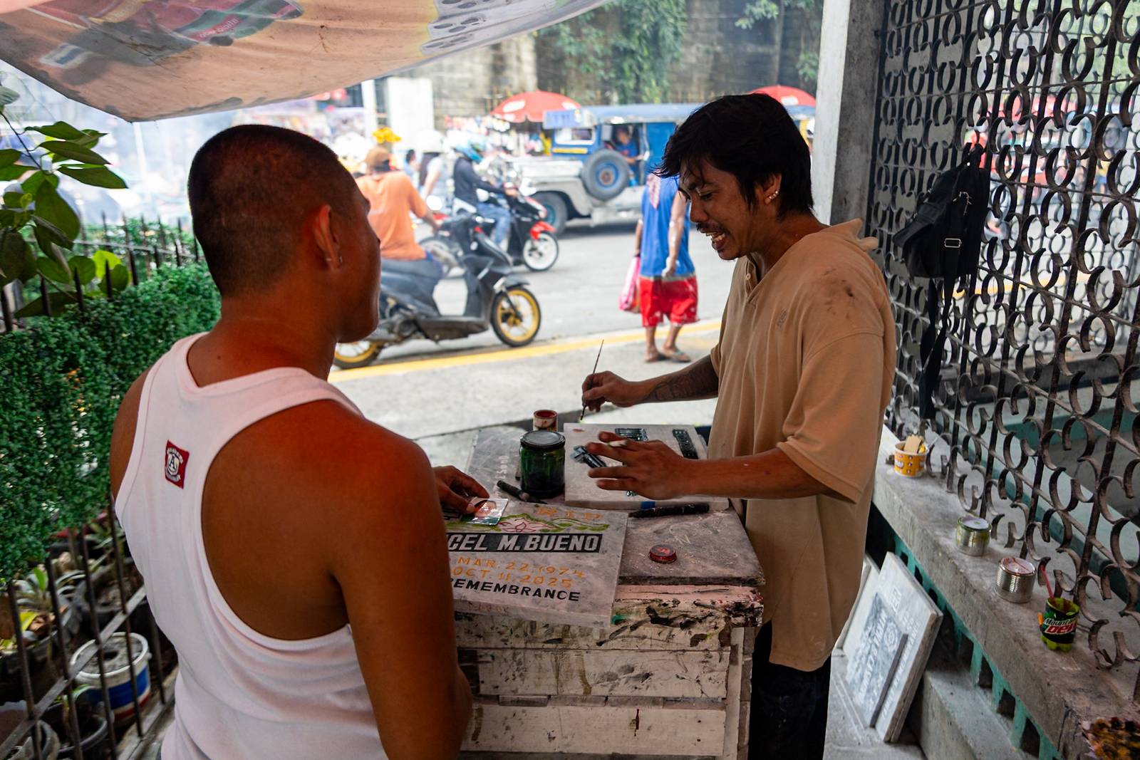 Tombstone maker Socsoc Gamurot engraves and paints names on a marble slab at his makeshift workshop inside the Manila North Cemetery as the annual observance of All Saints’ Day approaches.

 he 40-year-old, who resides inside the country’s largest cemetery, shares that each tombstone costs ₱1,200 and that he crafts an average of 10 pieces a day.