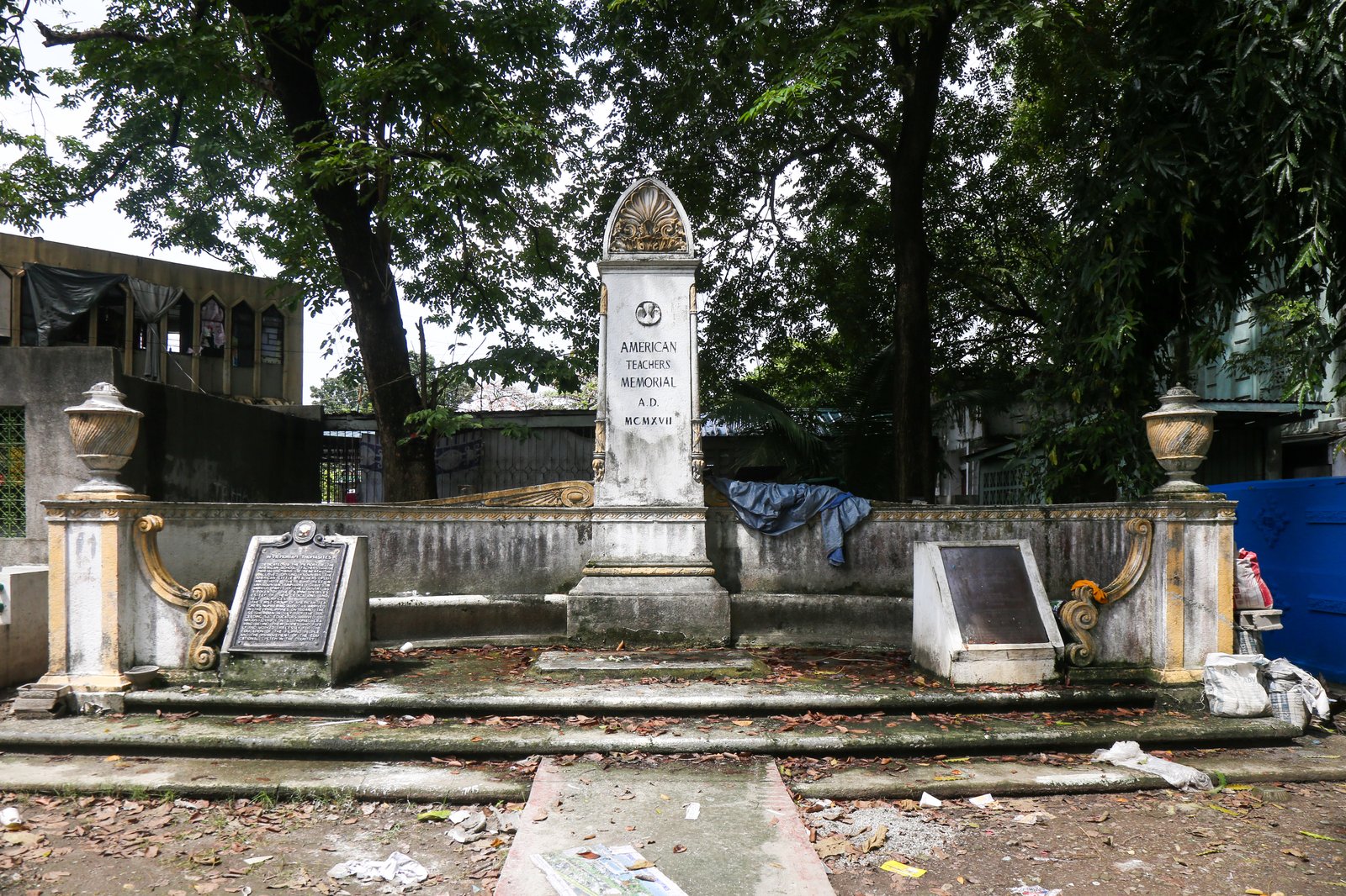 Dried leaves, single use plastics and discarded tarp sheet can be seen at the American Teachers Memorial inside Manila North Cemetery on this photo taken on 28 October 2025. Known also as the The American Little Teachers Plot, the memorial is dedicated to the American teachers who travelled to the Philippines in USS Thomas.