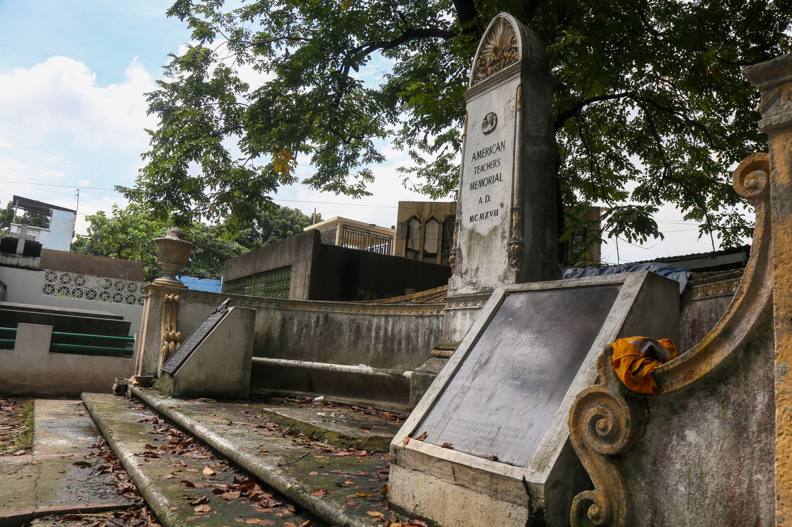 Dried leaves, single use plastics and discarded tarp sheet can be seen at the American Teachers Memorial inside Manila North Cemetery on this photo taken on 28 October 2025. Known also as the The American Little Teachers Plot, the memorial is dedicated to the American teachers who travelled to the Philippines in USS Thomas.