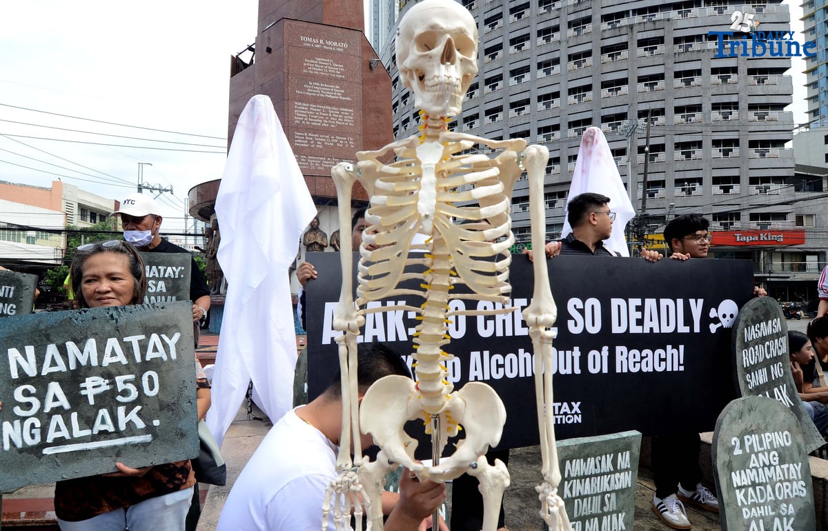 (October 28 2025) Youth leaders and members of the Sin Tax Coalition hold a halloween themed action at Brgy. South Triangle, Quezon City on Tuesday October 28 2025, to urge for higher alcohol taxes amid rising deaths and illnesses among young people of alcohol related. The symbolic action titled “So Cheap, So Deadly” feature tombstones representing lives lost to alcohol and ghost figures representing the alcohol industry. The campaign seeks to urge lawmakers to pass stronger alcohol control measures, including higher alcohol taxes, to protect young people. Photo/Analy Labor