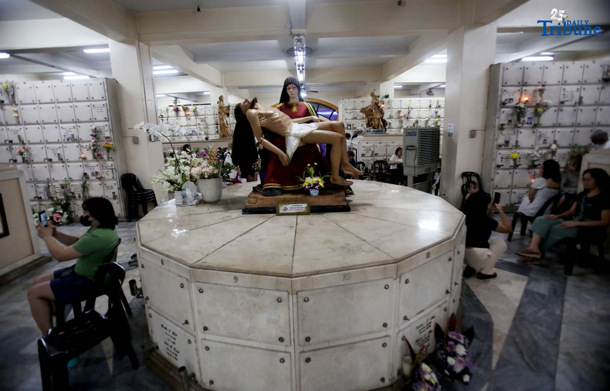 (November 01 2025) On All Saints Day Celebration Families offer flowers, prayers and light candles as they pay respect to their loved ones during the visit of their departed loved ones at St. Peter Parish and Shrine Columbarium on Saturday November 1 2025. Photo/Analy Labor
