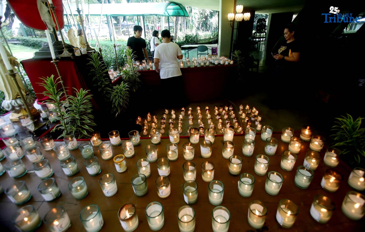(November 01 2025) On All Saints Day Celebration Families offer prayers and light candles to their departed loved ones at the Parish of the Holy Sacrifice in University of the Philippines, Quezon City, on November 1 2025. Photo/Analy Labor