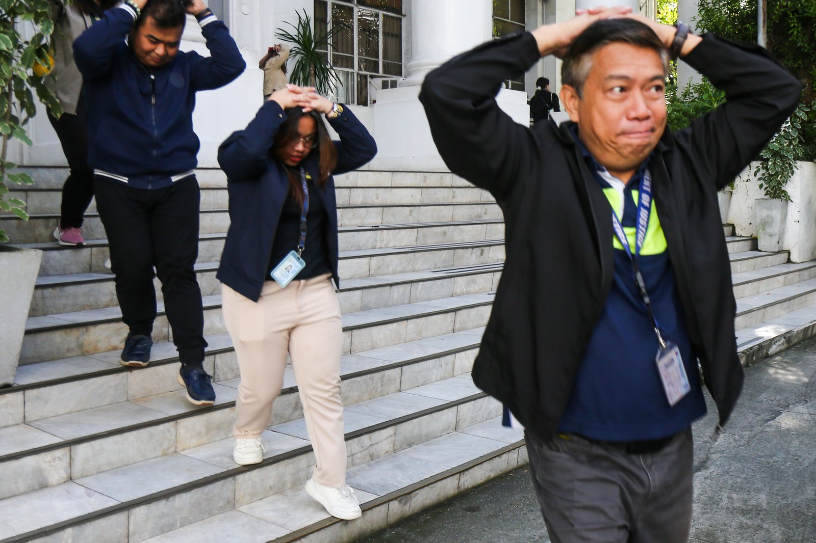 Department of Justice personnel evacuate to the open parking area during the Nationwide Simultaneous Earthquake Drill (NSED) at Padre Faura, Manila, on Thursday morning, 06 November 2025. The drill aims to raise public awareness and strengthen preparedness for potential earthquakes.