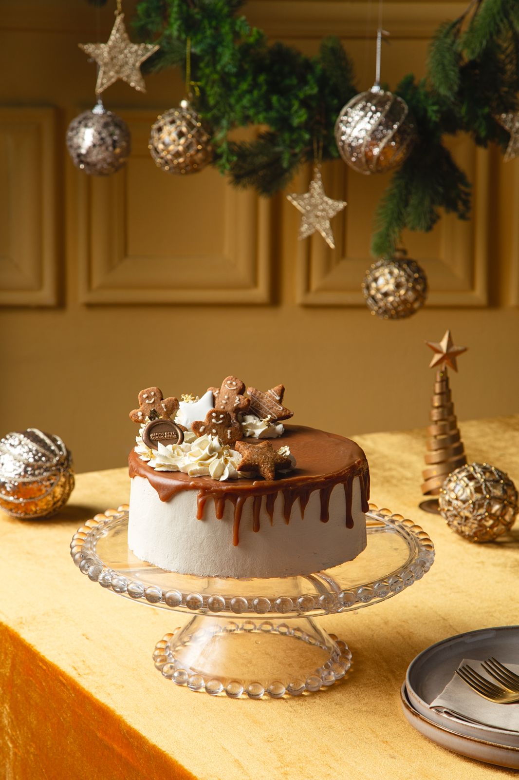 The hotel’s signature Christmas cake, topped with caramel drip and gingerbread accents.