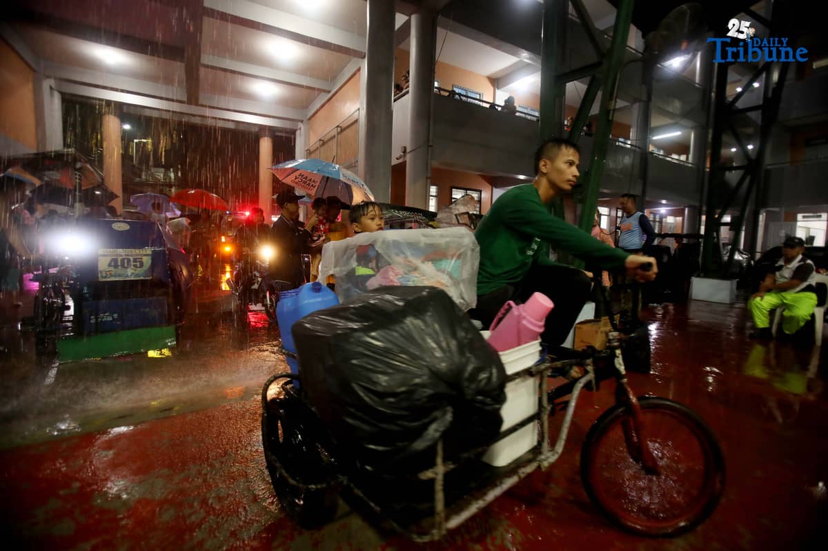 Residents living near the Marikina River arrive at H. Bautista Elementary School in Marikina City after evacuating their homes on 9 November 2025, as a preemptive measure ordered by the local government ahead of Super Typhoon Uwan.