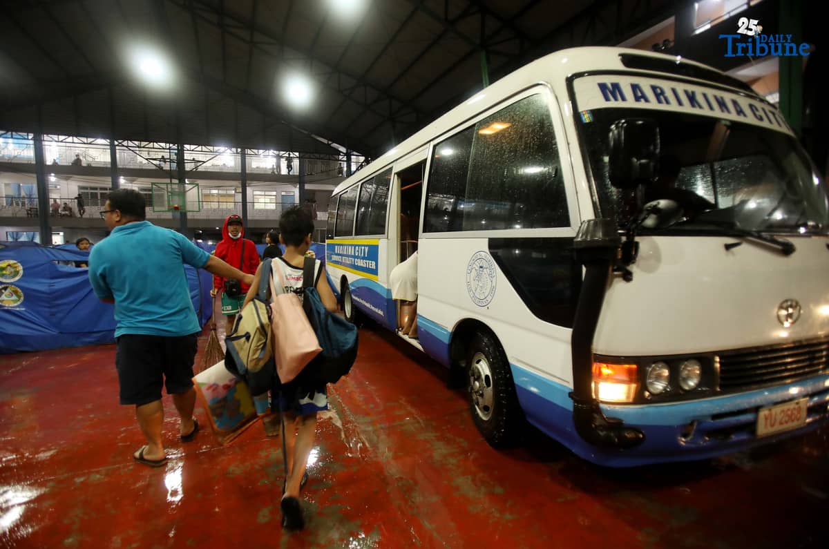 Residents living near the Marikina River arrive at H. Bautista Elementary School in Marikina City after evacuating their homes on 9 November 2025, as a preemptive measure ordered by the local government ahead of Super Typhoon Uwan.