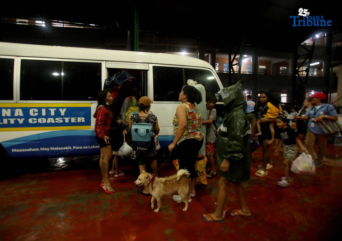 Residents living near the Marikina River arrive at H. Bautista Elementary School in Marikina City after evacuating their homes on 9 November 2025, as a preemptive measure ordered by the local government ahead of Super Typhoon Uwan.